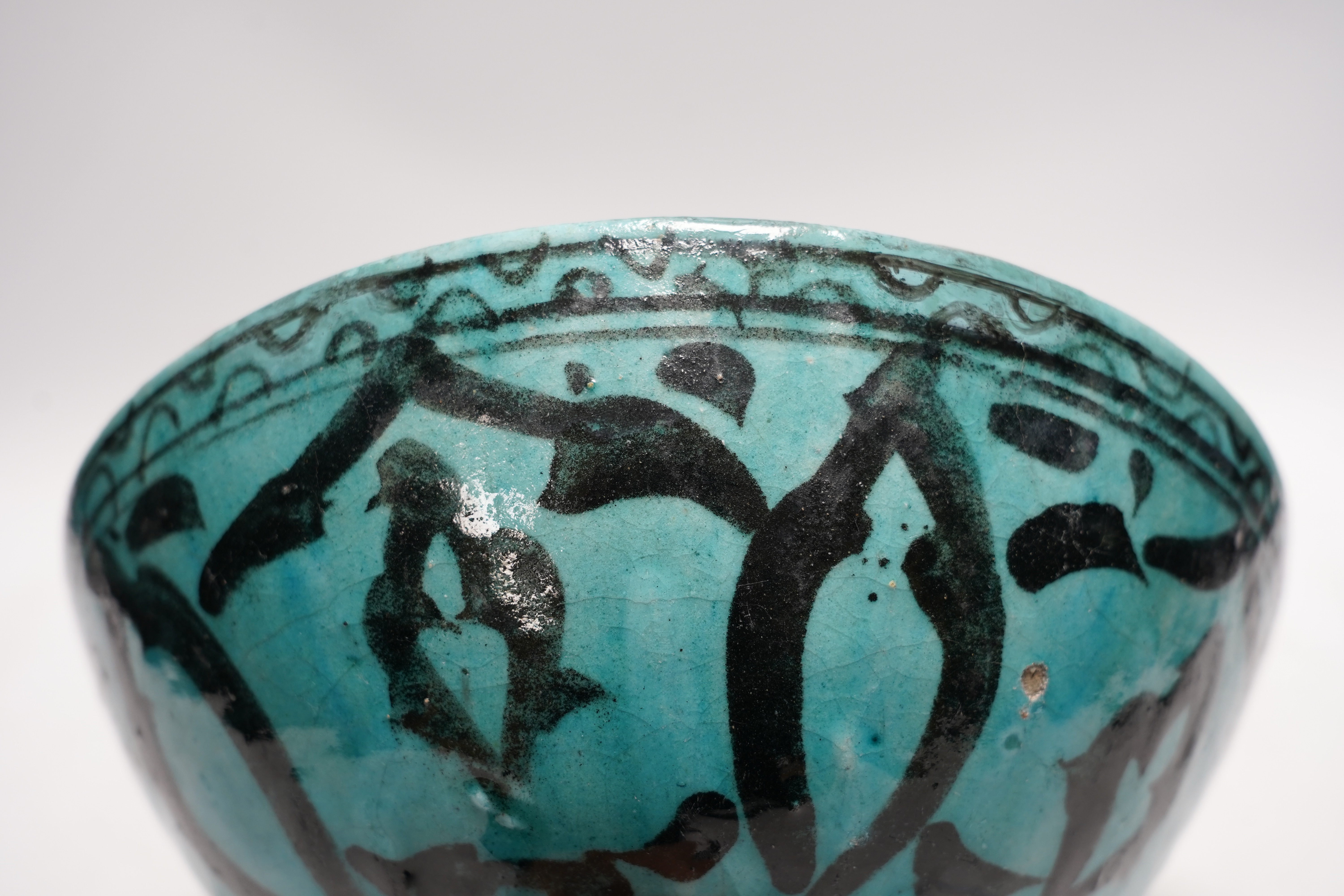 A Kashan turquoise glazed fritware bowl, Persia, 13th/14th century, 25cm diameter
